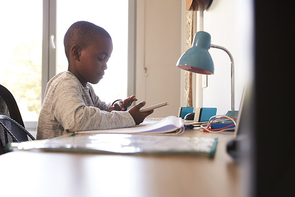 Child using his short-term memory and long-term memory to do his homework