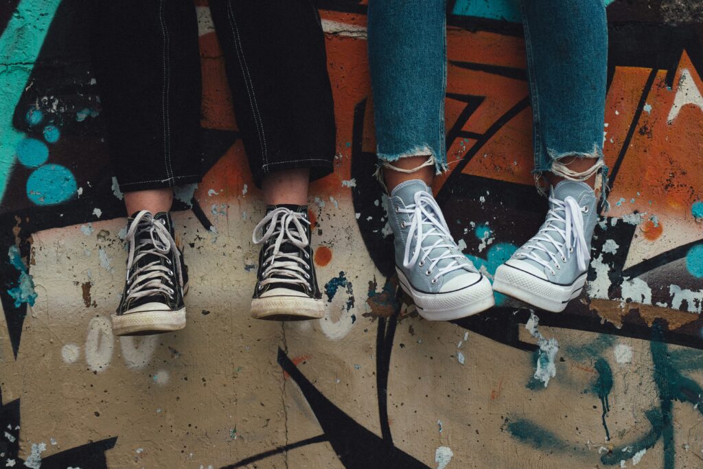 Legs of two friends sitting.