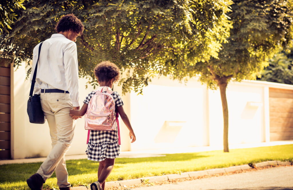 father praising child on the walk to school.