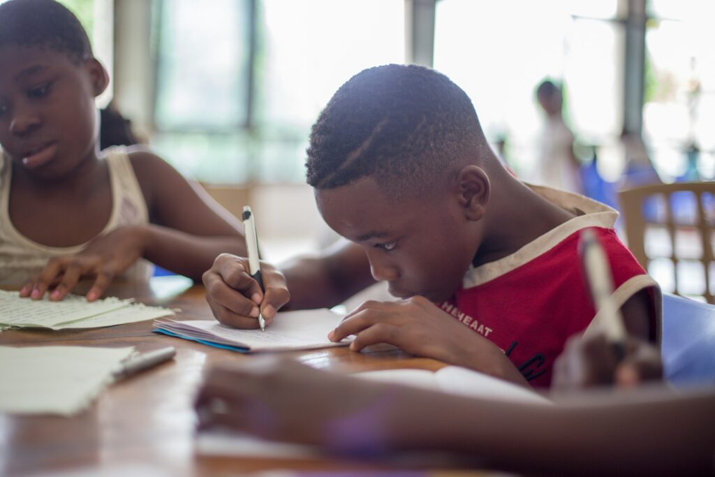 Boy working on adapting a growth mindset vs a fixed mindset while doing schoolwork